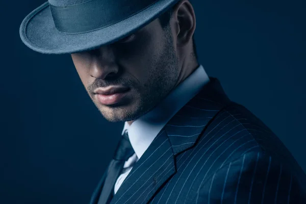 Portrait of mafioso in felt hat on dark blue background — Stock Photo