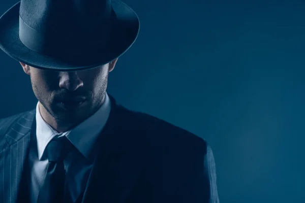 Portrait of mafioso with covered eyes with felt hat on dark — Stock Photo