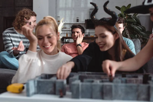 KYIV, UKRAINE - JANUARY 27, 2020: selective focus of happy girls in fairy costumes playing labyrinth board game near friends — Stock Photo