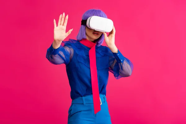 Fashionable pop art girl in blue blouse using vr headset, isolated on pink — Stock Photo