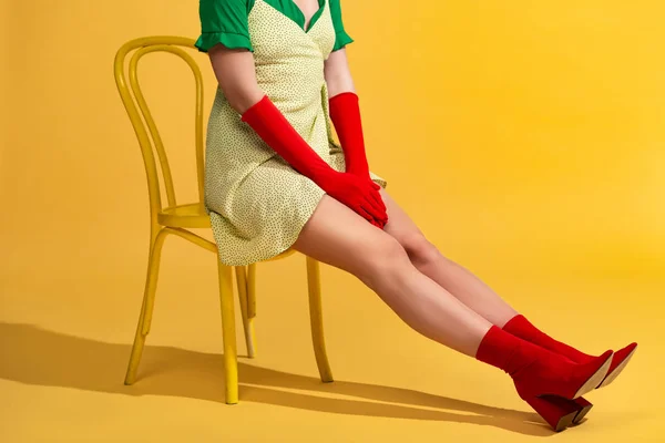 Cropped view of pop art girl sitting on chair — Stock Photo