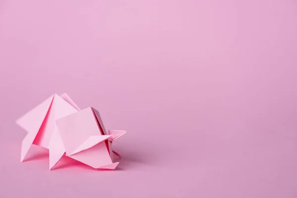 Small paper rhinoceros on pink with copy space — Stock Photo