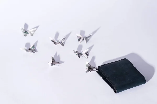 Decorative money origami butterflies near wallet on white — Stock Photo