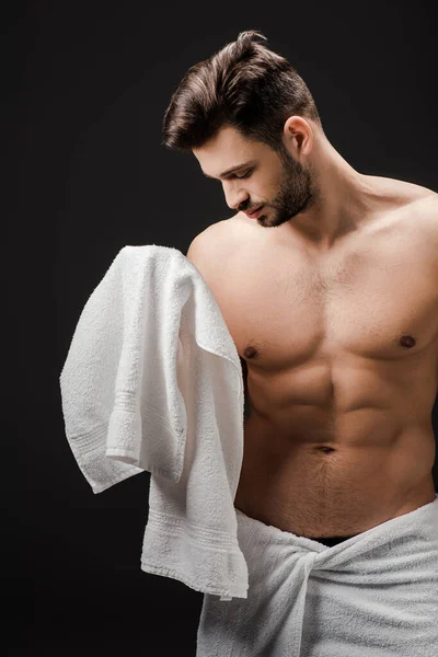 Bearded brunette man with towel isolated on black — Stock Photo