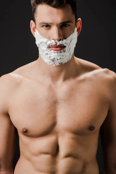 Sexy naked man with shaving foam on face isolated on black — Stock Photo
