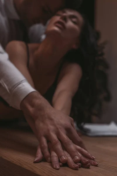 Selective focus of businessman hugging sexy secretary and touching her hand — Stock Photo