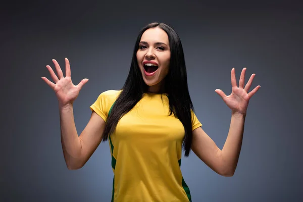 Excited attractive girl gesturing with open mouth on grey — Stock Photo