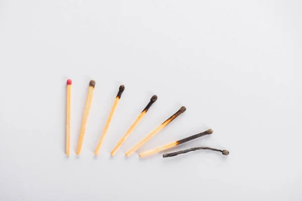 Top view of matchsticks transformation phases on white — Stock Photo