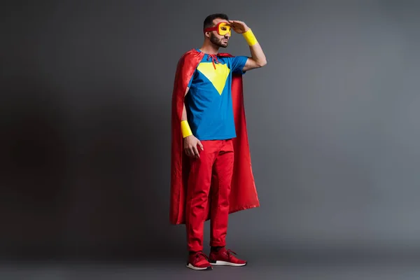 Superhéroe barbudo en capa y máscara en gris - foto de stock