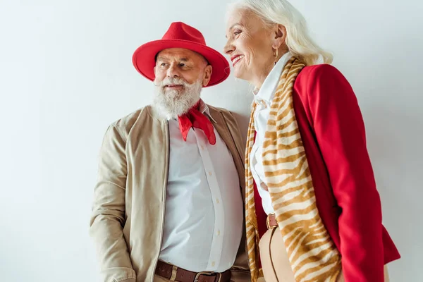 Stylish senior couple smiling away on white background — Stock Photo