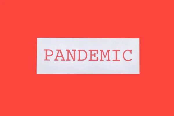 Top view of pandemic lettering isolated on red — Stock Photo