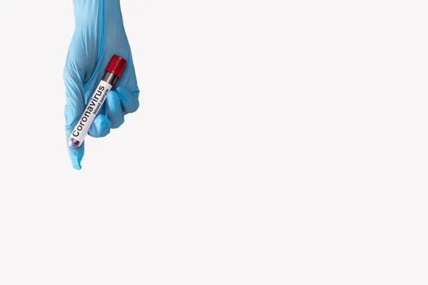 Top view of doctor in latex glove holding test tube with blood sample and coronavirus lettering isolated on white — Stock Photo
