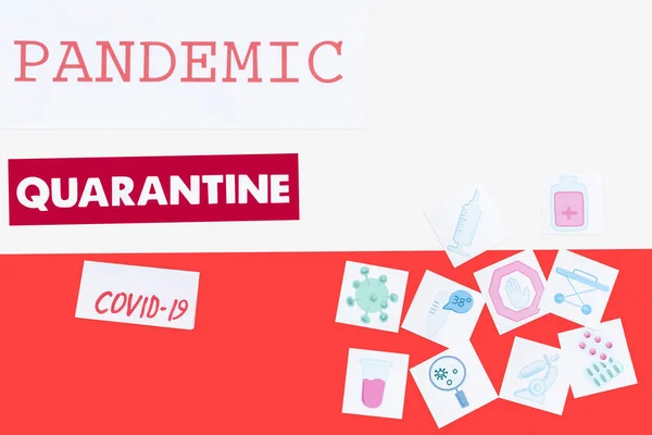 Top view of pandemic, quarantine and covid-19 lettering near drawn medical pictures on polish flag — Stock Photo