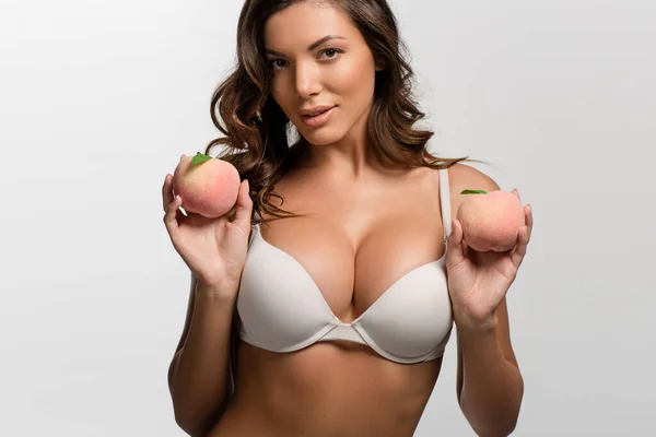 Seductive girl with big breasts holding ripe apples isolated on white — Stock Photo