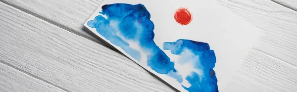Top view of paper with Japanese painting with clouds and sun on wooden background, panoramic shot — Stock Photo