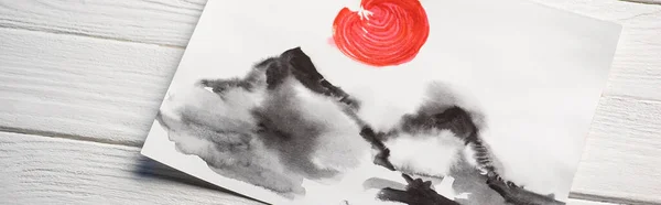 Draufsicht auf Papier mit japanischer Malerei mit Hügeln und roter Sonne auf Holzgrund, Panoramaaufnahme — Stockfoto