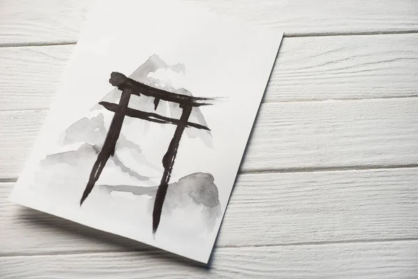 Vista superior de papel con pintura japonesa con jeroglífico sobre fondo de madera - foto de stock