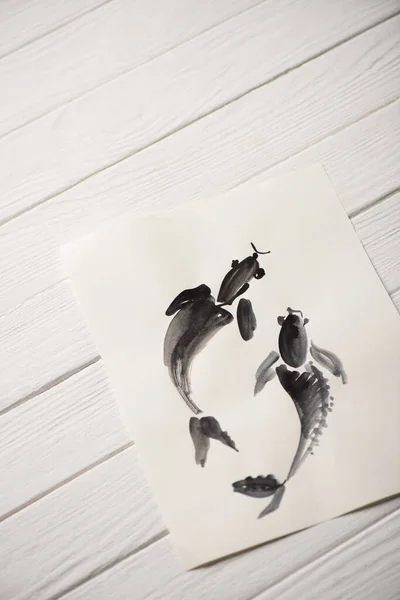 Draufsicht auf japanisches Bild mit bemalten Fischen auf Holzgrund — Stockfoto