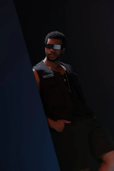 African american male model futuristic sunglasses in posing on dark blue — Stock Photo