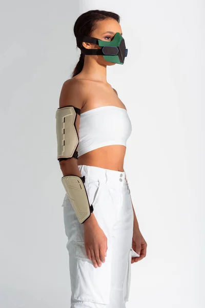 Futuristic african american woman in safety mask on white background — Stock Photo