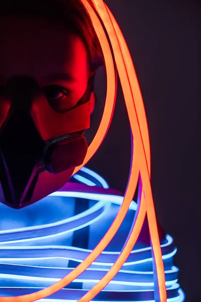 Cropped view of futuristic african american woman in respirator and neon lighting — Stock Photo