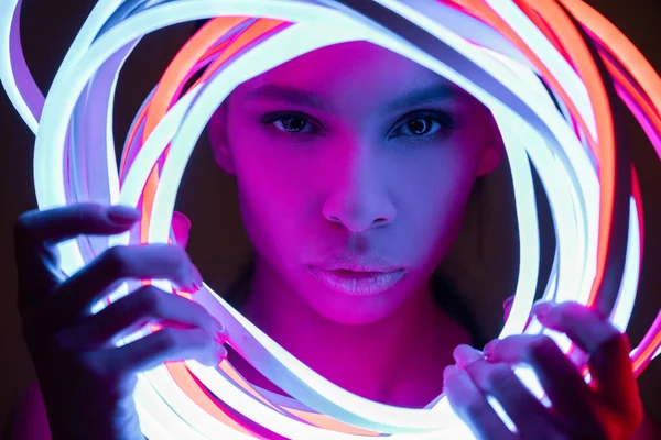 Portrait of futuristic african american woman in neon lighting — Stock Photo