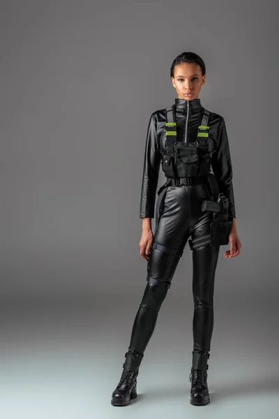 Young attractive futuristic african american woman on grey — Stock Photo
