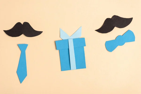 Top view of paper crafted fake mustache and decorative elements on beige background, fathers day concept — Stock Photo