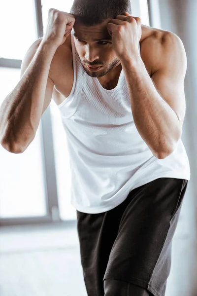 Handsome and strong fighter training in sports center — Stock Photo