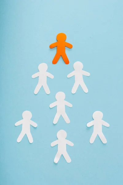 Posa piatta con l'uomo decorativo arancione unico tra bianco su sfondo blu — Foto stock