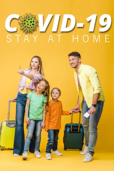 Happy family of travelers with luggage, passports and tickets pointing on yellow, covid-19 illustration — Stock Photo