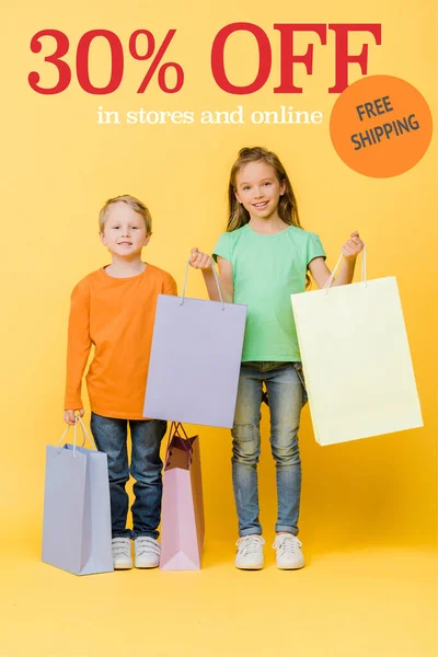 Adorable smiling kids holding shopping bags on yellow, 30 percent off sale illustration — Stock Photo