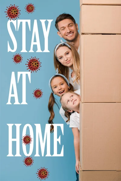 Happy parents and kids with cardboard boxes for relocation isolated on blue, bacteria and stay at home illustration — Stock Photo