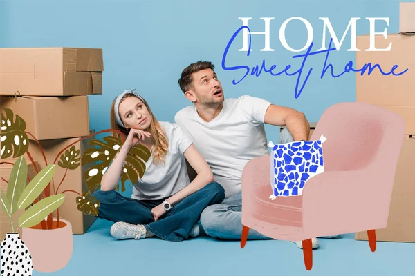 Dreamy couple sitting with cardboard boxes for relocation on blue, home sweet home illustration — Stock Photo