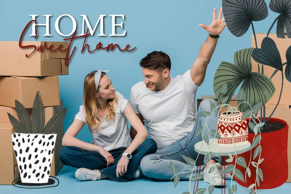 Pareja emocionada sentado cajas de cartón para la reubicación en azul, hogar dulce casa ilustración - foto de stock