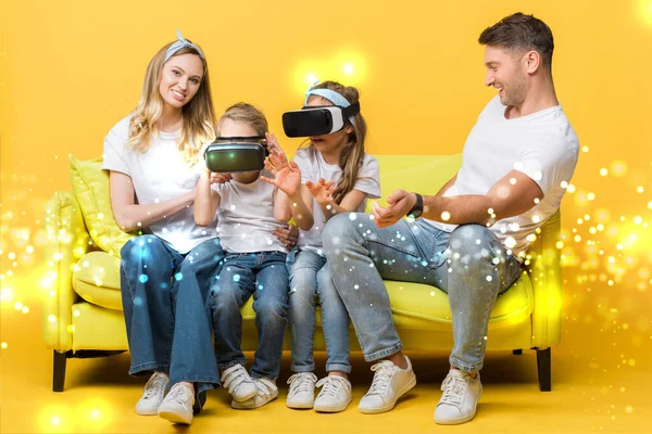 Happy parents with children in virtual reality headsets sitting on sofa on yellow, glowing illustration — Stock Photo