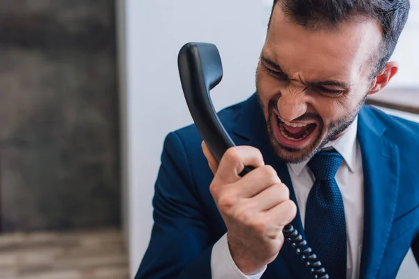 Aggressive collector shouting on handset in room — Stock Photo