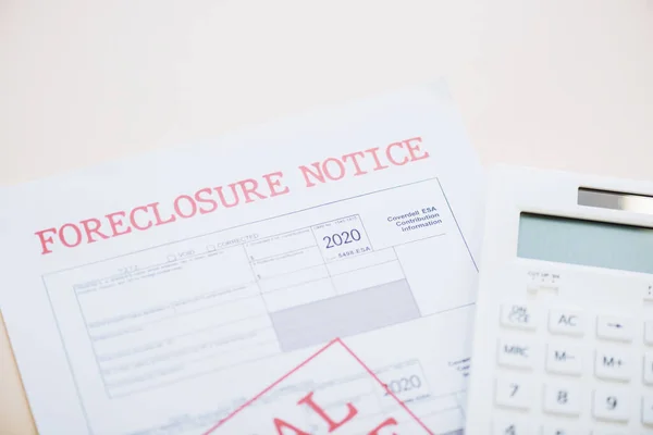 Top view of document with foreclosure lettering and calculator on white — Stock Photo