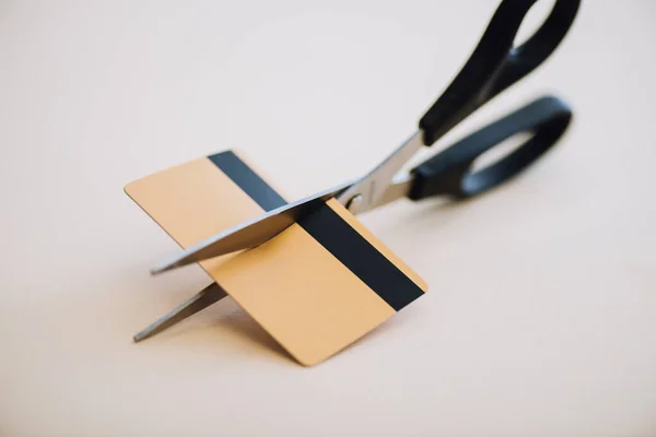 High angle view of credit card with scissors on white background — Stock Photo