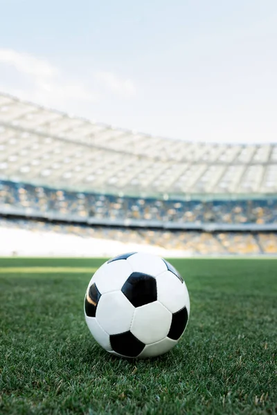 Soccer ball on grassy football pitch at stadium — Stock Photo