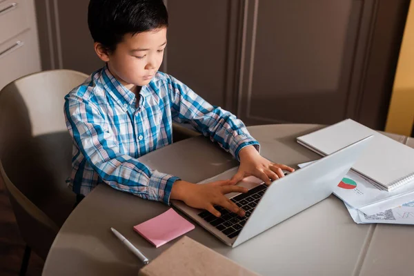 Asian boy studying online with laptop at home during quarantine — Stock Photo