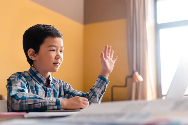 Азіатський хлопчик вивчає онлайн з ноутбуком вдома під час карантину — стокове фото