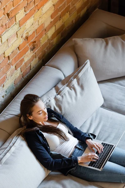 Overhead view of attractive freelancer typing on laptop keyboard at home — Stock Photo