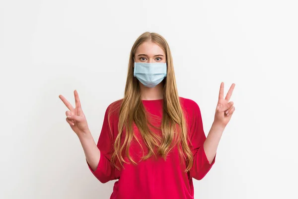 Young woman in medical mask showing peace sign isolated on white — Stock Photo