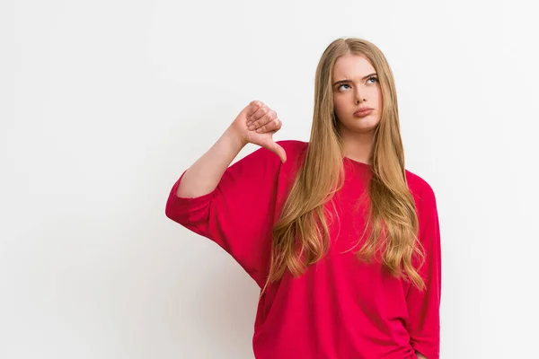 Displeased girl showing thumb down isolated on white — Stock Photo
