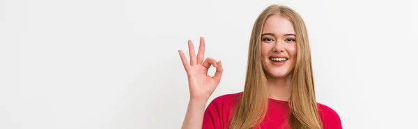 Panoramic concept of cheerful woman showing ok sign isolated on white — Stock Photo