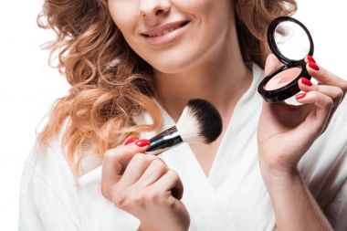Woman applying makeup  clipart