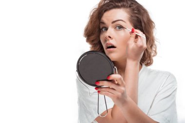 woman putting eyeliner clipart