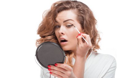 woman putting eyeliner clipart