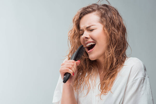 woman singing with hair comb